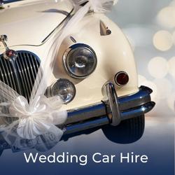Luxury white car decorated with ribbons and bows for a wedding, link to limousines and wedding cars availbel to hire